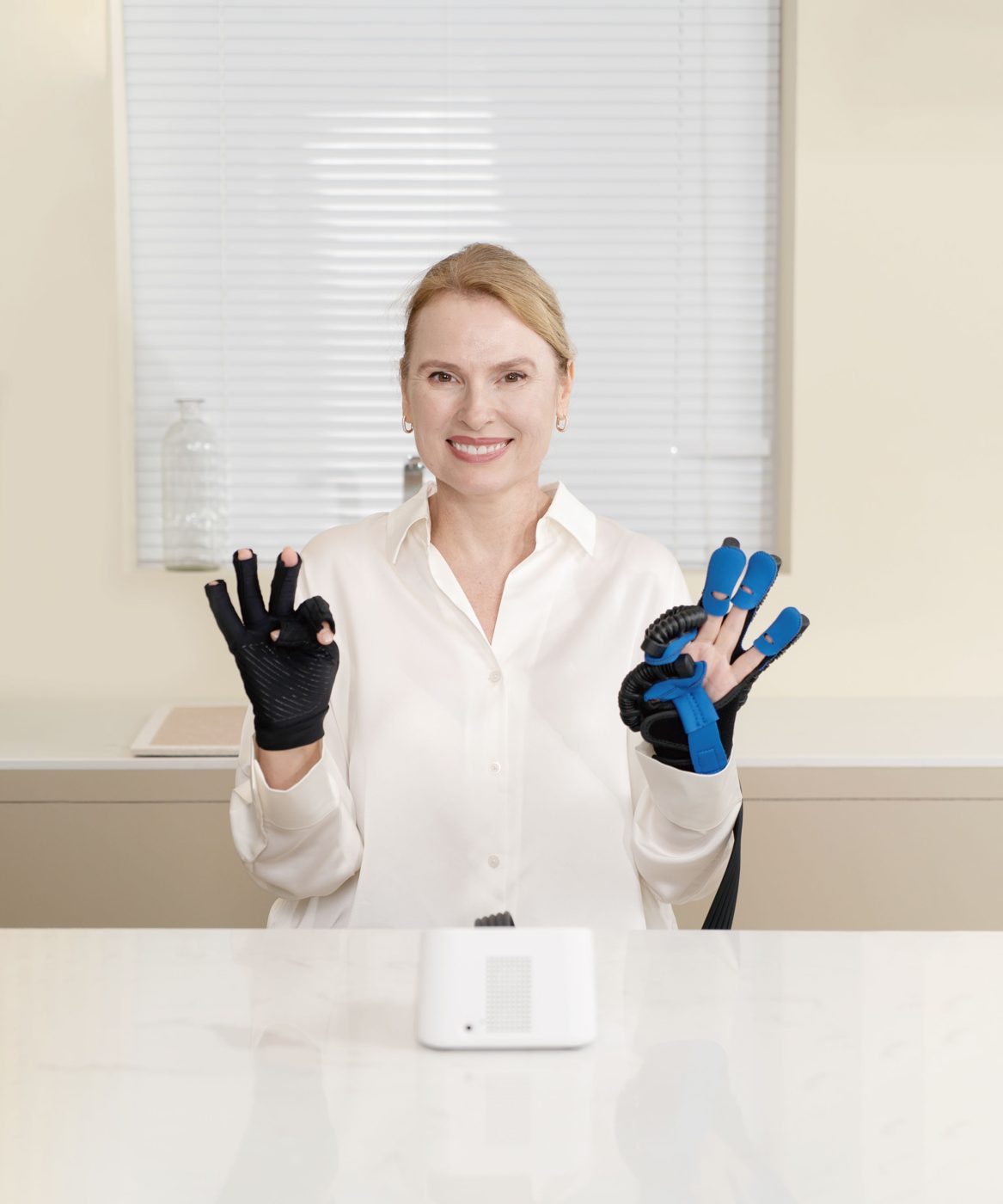 Woman wearing a soft robotic hand rehabilitation glove during finger exercise